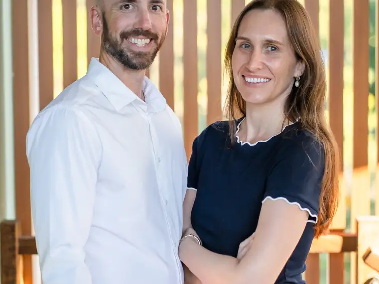 Two Grove Support Services team members standing side by side, relaxed and approachable